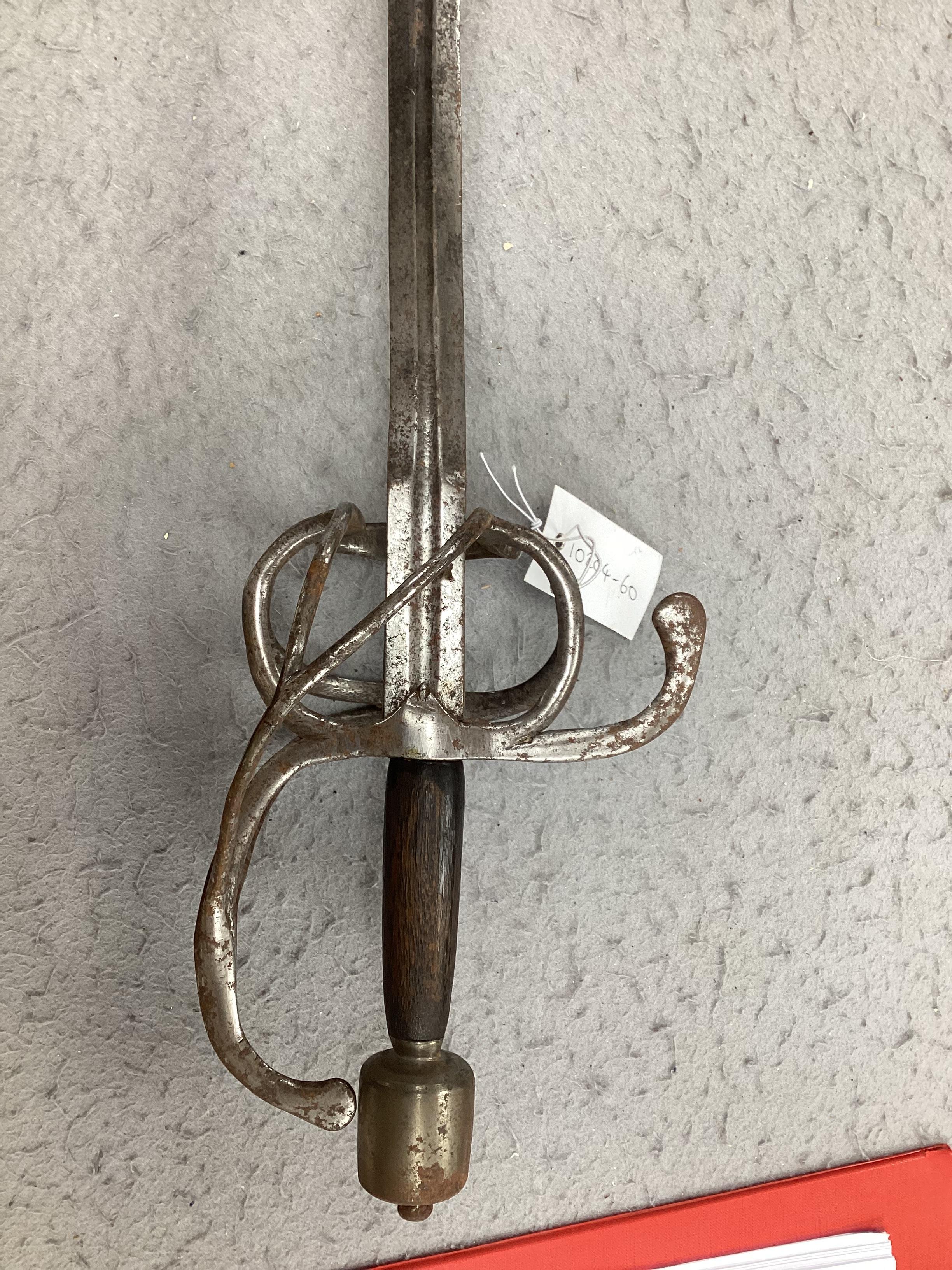 A swept hilt rapier, c.1620, blade fullered at the forte, iron guard of conventional form with later pommel and wooden grip, blade 113cm